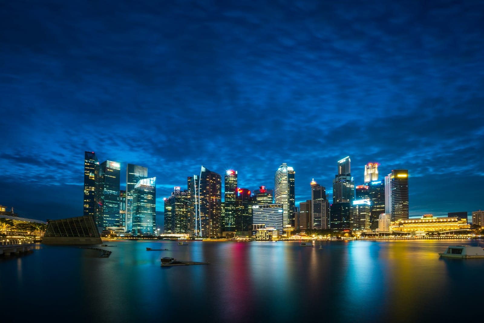 Singapore skyline across the water under a cloudy sky